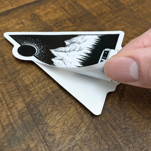 black and white mountain sticker being peeled