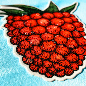 red vinyl laptop sticker with water droplets on it's surface