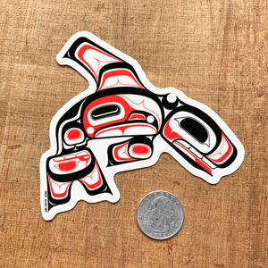 tlingit killer whale laptop vinyl sticker next to a quarter