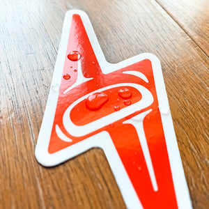 water droplets on the surface of a red native american lightning bolt vinyl sticker